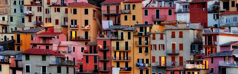 An array of colourful buildings on a hillside, stacked vertically